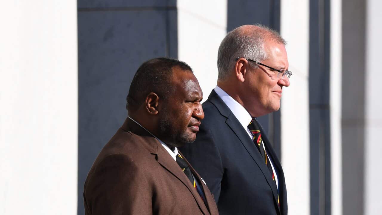 Prime Minister of Papua New Guinea James Marape and Australian Prime Minister Scott Morrison inspect the guard of honour during the official welcome ceremony.
