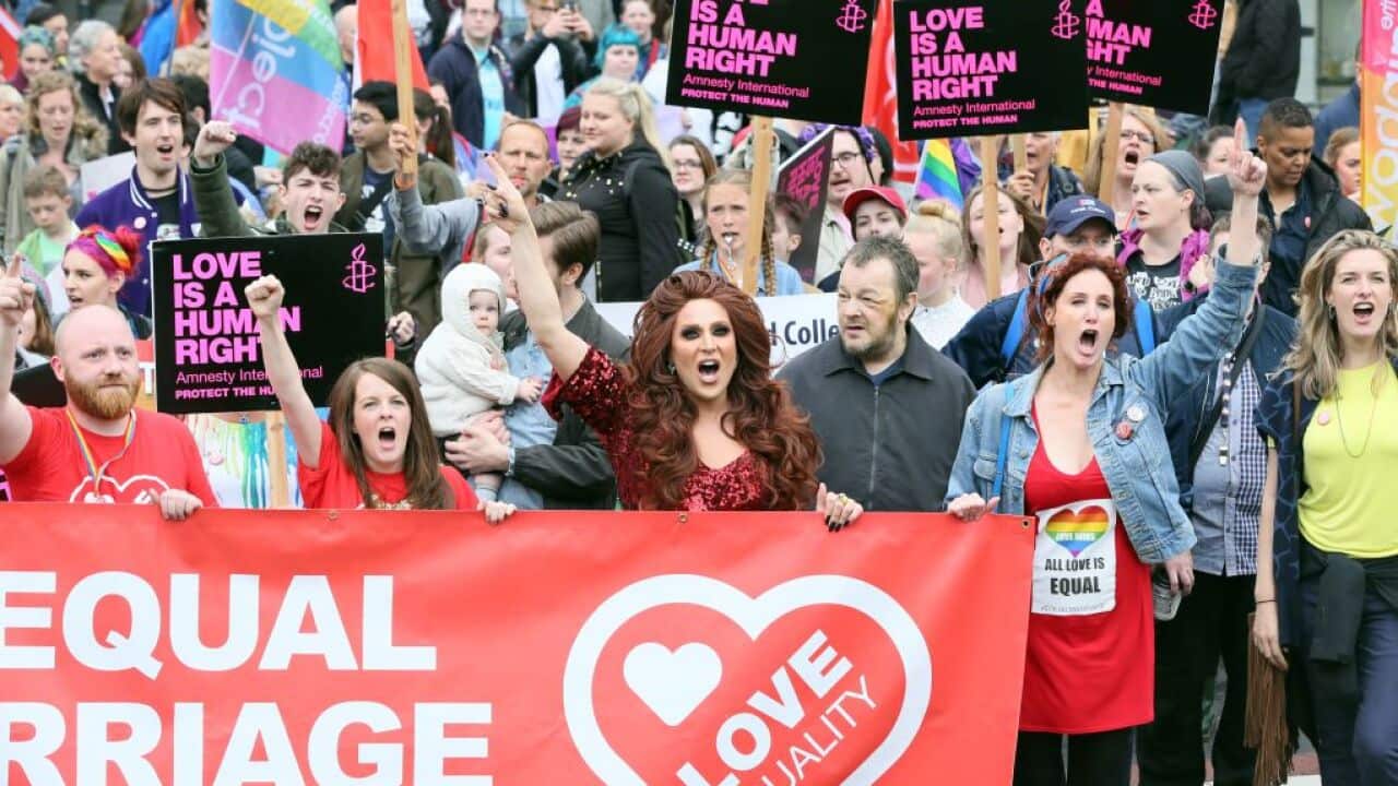 Same-sex marriage campaigners take part in a march through Belfast on July 1, 2017 to protest against the ban on same-sex marriage.