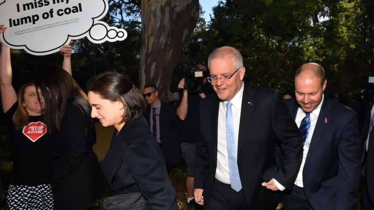 Scott Morrison, Treasurer Josh Frydenberg, and anti-Adani activists.
