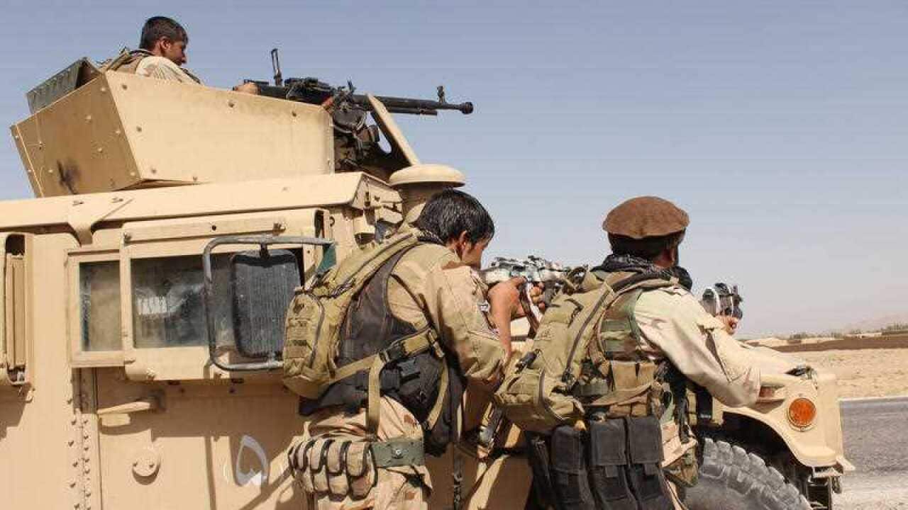 Afghanistan's security forces take their position during a clash by Taliban fighters.