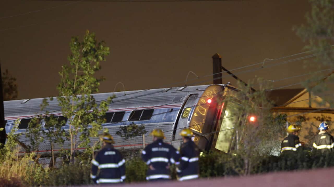 Emergency personnel work at the scene of a train wreck