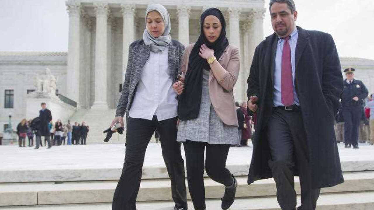 Samantha Elauf, center, her mother Majda Elauf, left, and P. David Lopez, General Counsel of the US Equal Employment Opportunity Commission (EEOC), leave the Supreme Court in Washington, Wednesday, Feb. 25, 2015.