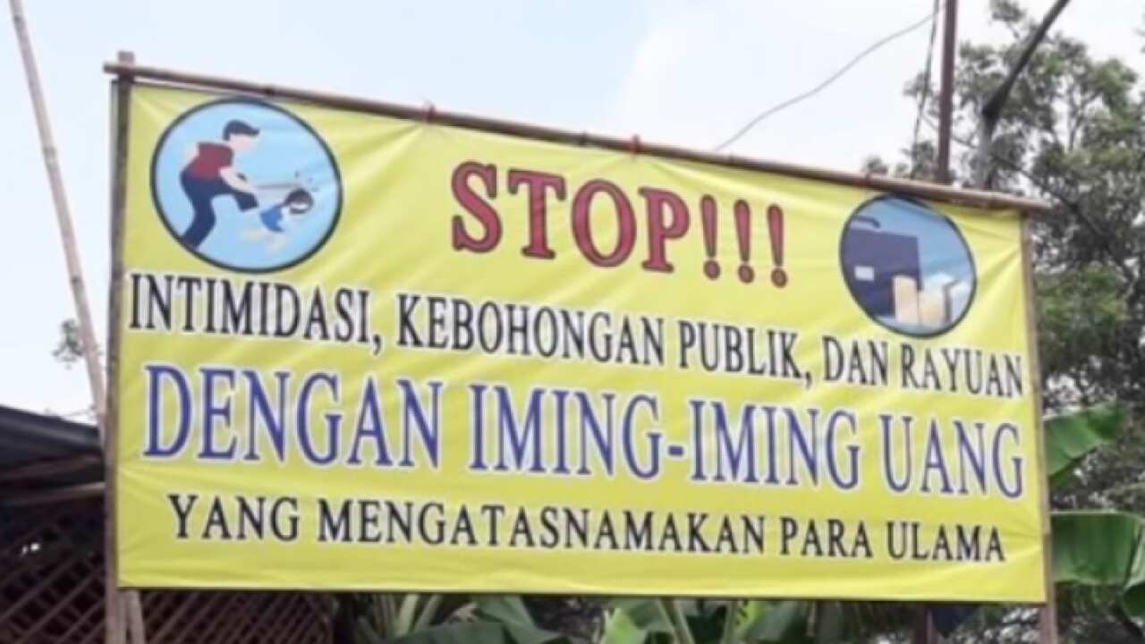 A group of people put up billboards against the construction of a temple in the village of Sukahurip, Bekasi Regency, West Java.