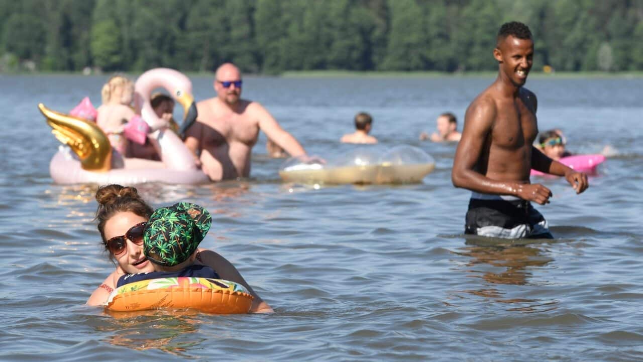 People enjoy a hot summer day at a lake in Espoo, Finland on June 26, 2020.