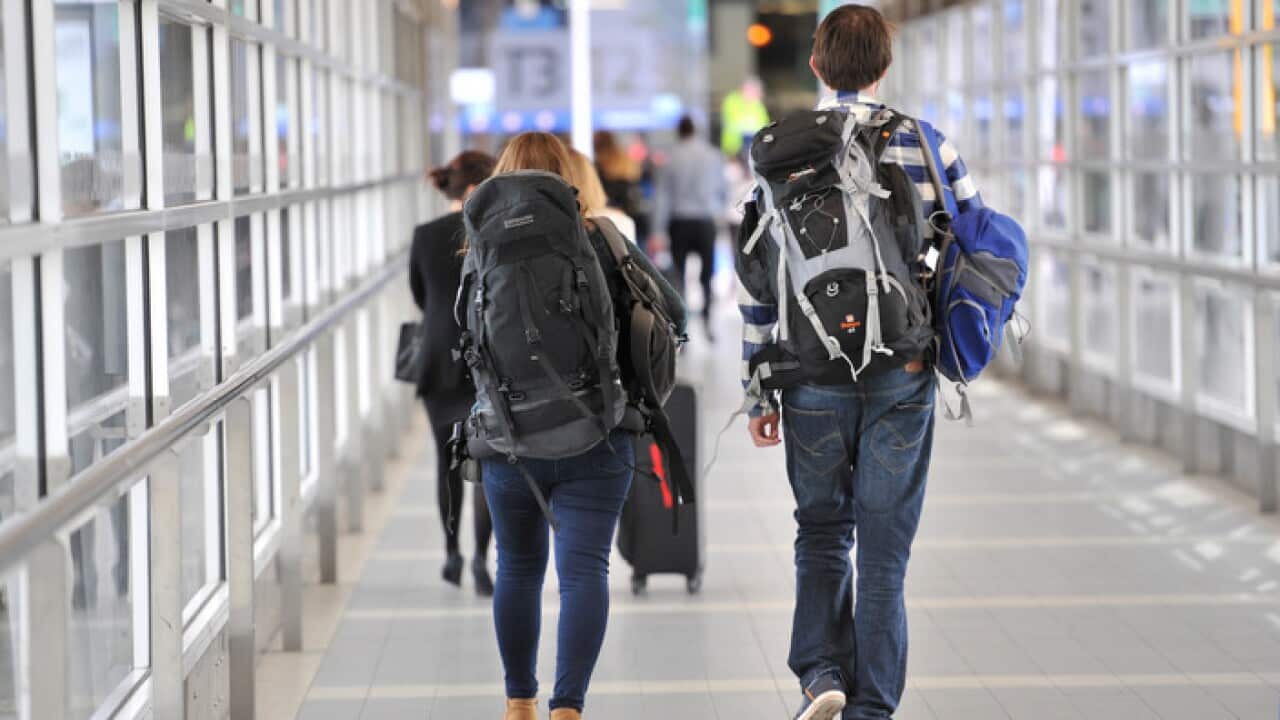 Backpackers make their way to the international terminal at Melbourne Airport in Melbourne.