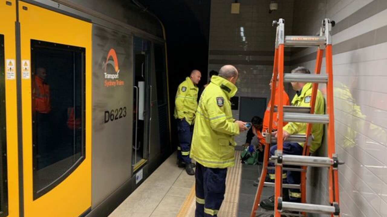 Workers attend to a technical issue which prompted mass delays on the Sydney rail network.