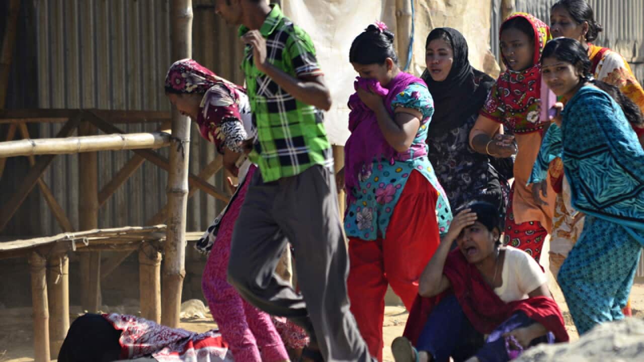 Bangladeshi garment workers reacting to fired tear gas shells
