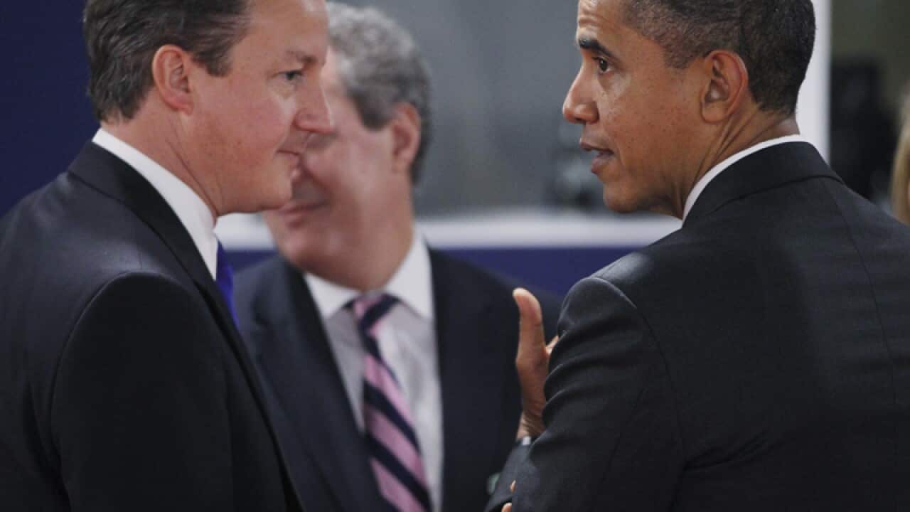 U.S. President Barack Obama (R) talks with British PM David Cameron