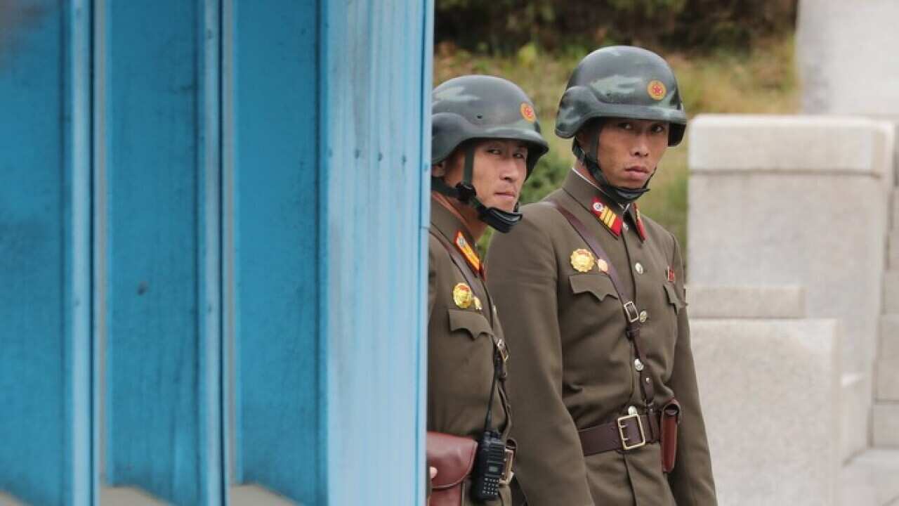 North Korean guards watch the South Korean side of the inter-Korean truce village of Panmunjom,