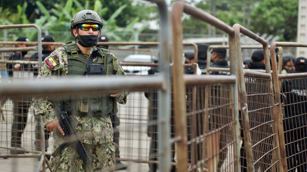 A policeman stands guard outside the Guayas 1 prison after a violence outburst between the inmates that left 58 deaths in Guayaquil, 13 November, 2021.