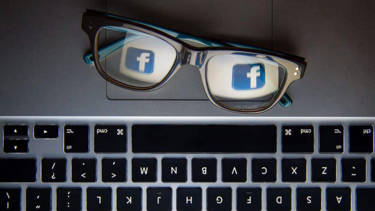 Facebook's logo reflected in a pair of glasses