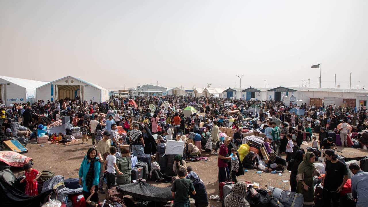 Groups of people sitting in an open area outside