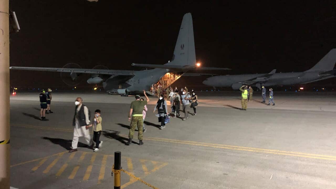 Evacuees from Afghanistan disembark an RAAF Hercules