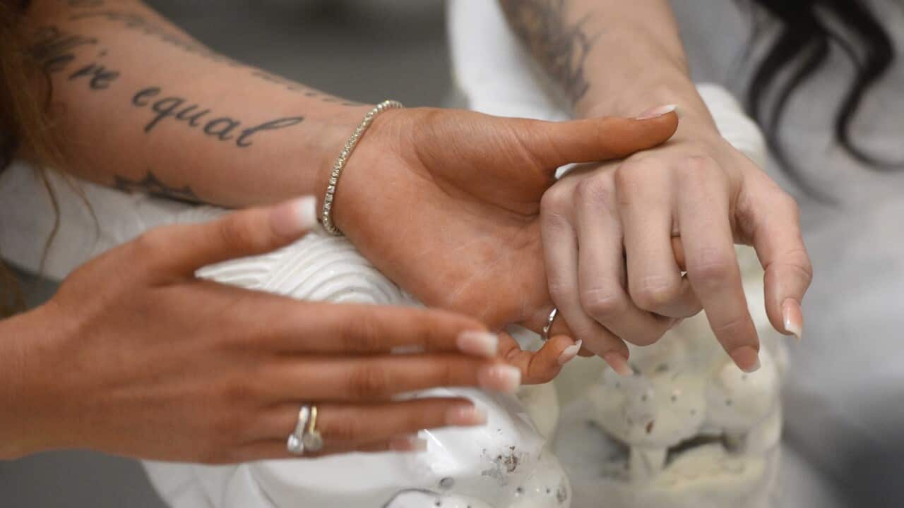 Robyn Peoples, 26, (L) and Sharni Edwards, 27, (R) get married in Loughshore Hotel in Carrickfergus, Northern Ireland.