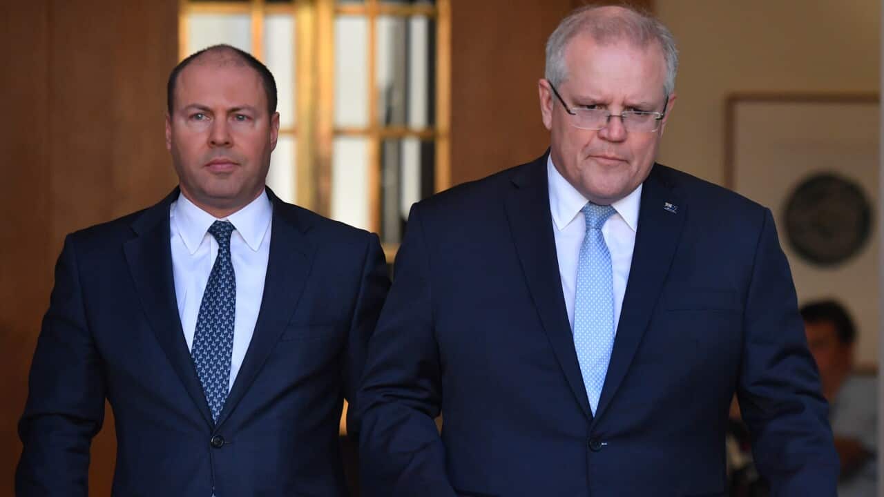 Treasurer Josh Frydenberg and Prime Minister Scott Morrison arrive at a press conference to announce the government's coronavirus stimulus package at Parliament House in Canberra, Sunday, March 22, 2020. (AAP Image/Mick Tsikas) NO ARCHIVING