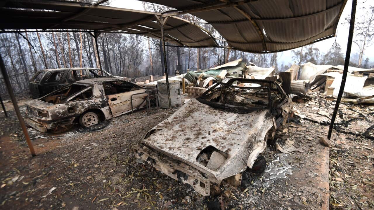 The remains of cars and a house destroyed by bushfire are seen outside of Glenreagh, near Coffs Harbour