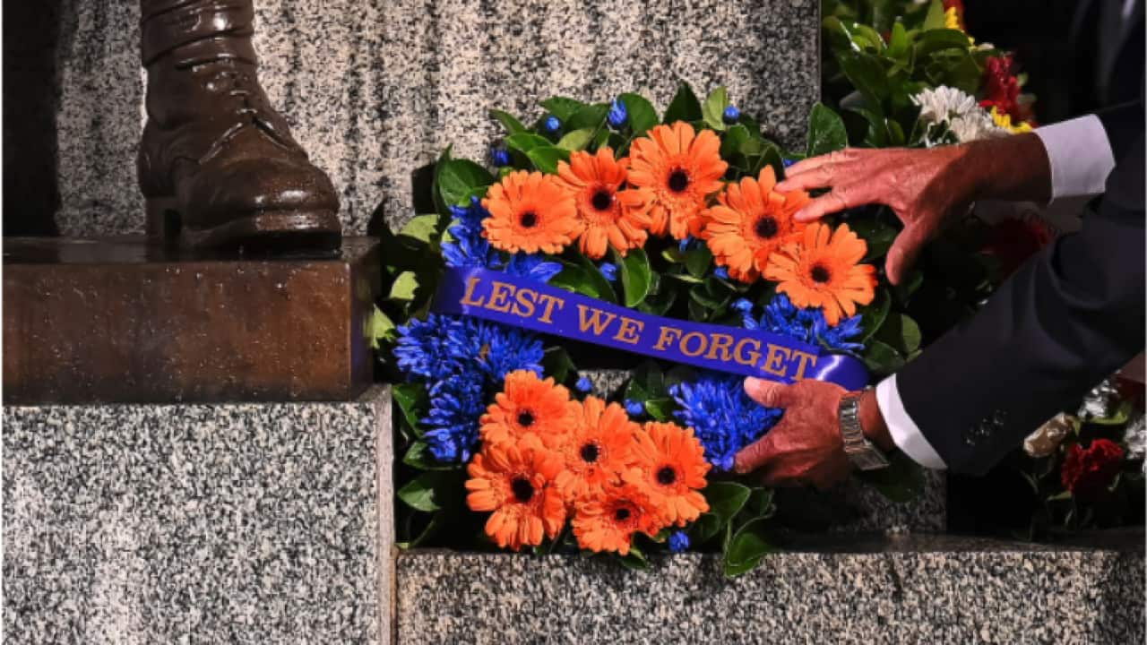 A tribute left by a member of the public rests against the Cenotaph during the annual Anzac Day Dawn Service at Martin Place in Sydney.