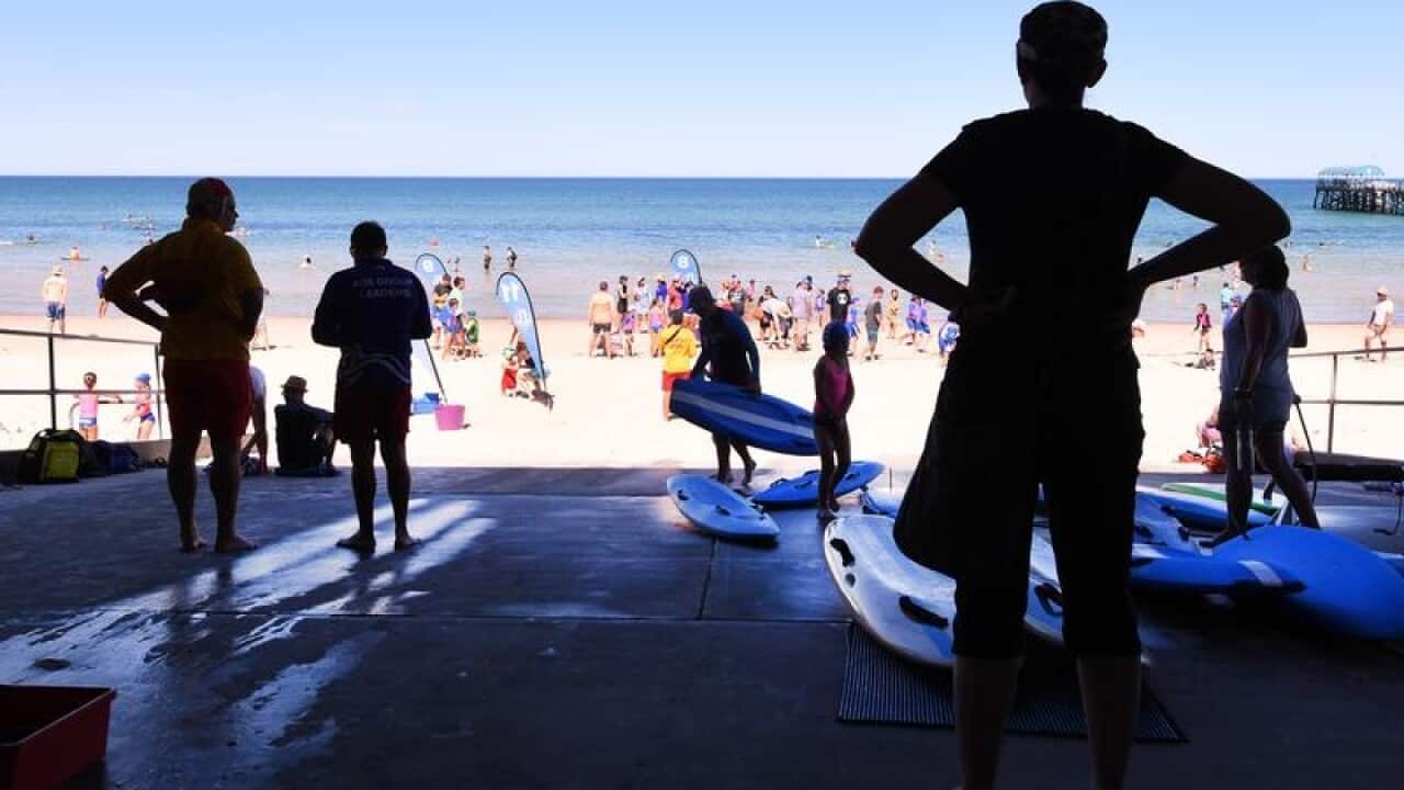 Beachgoers at Henley Beach in Adelaide
