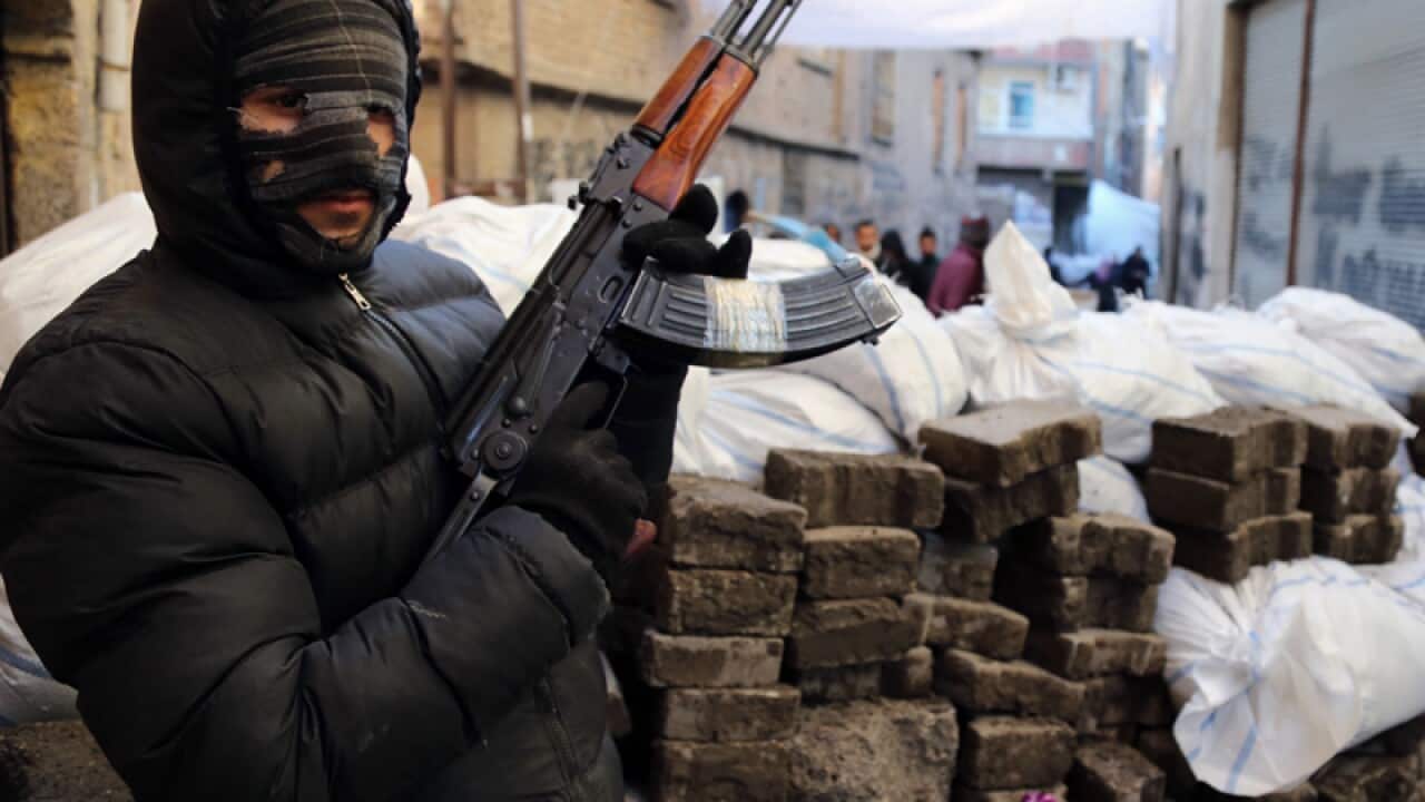 A PKK militant stands at a barricade in Diyarbakir