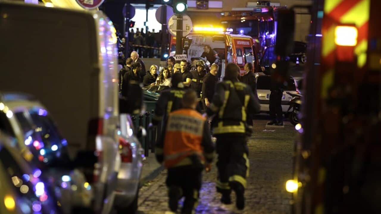 Police and rescuers work at the scene of an attack in the 10th arrondissement of the French capital Paris, on November 13, 2015. (AFP)