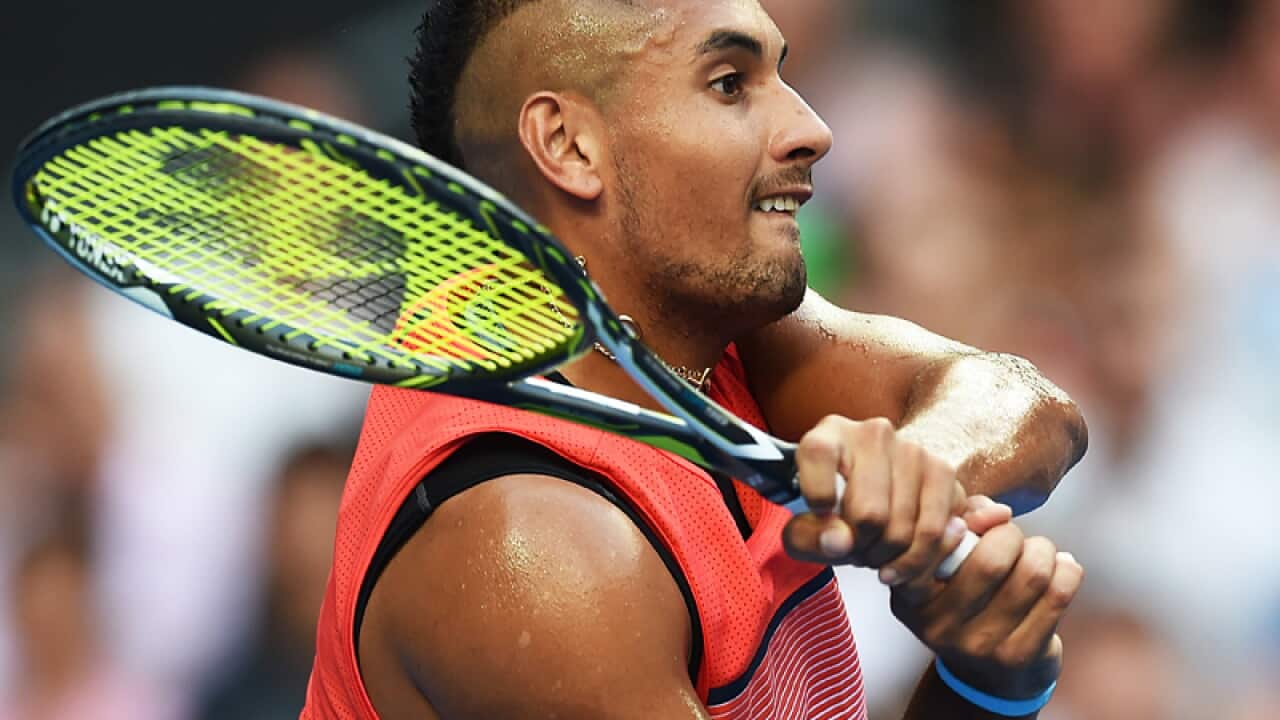 Nick Kyrgios of Australia plays a backhand return