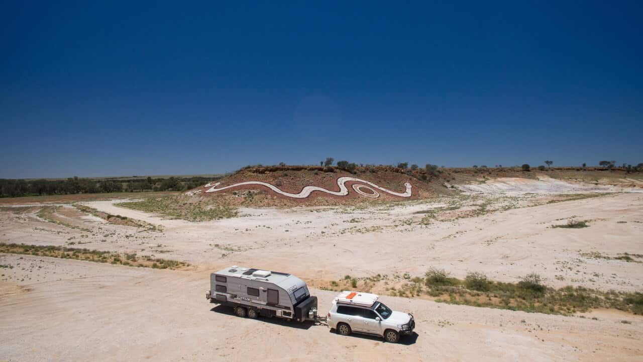 Wide shot of a caravan and 4wd in outbakc queensland