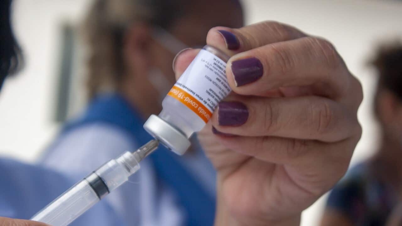 A doctor prepares to administer a dose of the Oxford-AstraZeneca vaccine