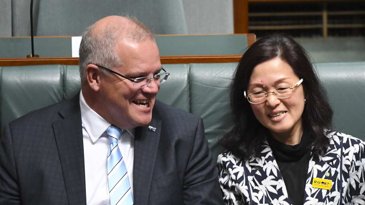 Prime Minister Scott Morrison sits next to Liberal MP Gladys Liu