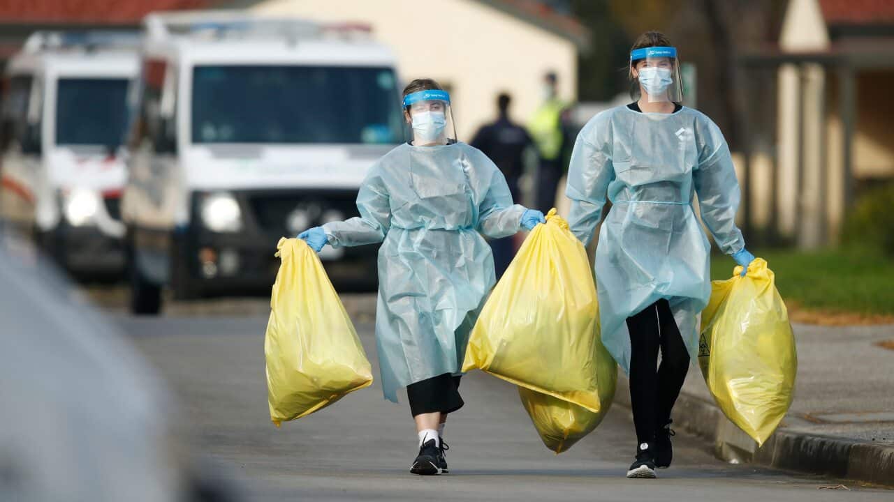 Medical staff with bags of clinical waste