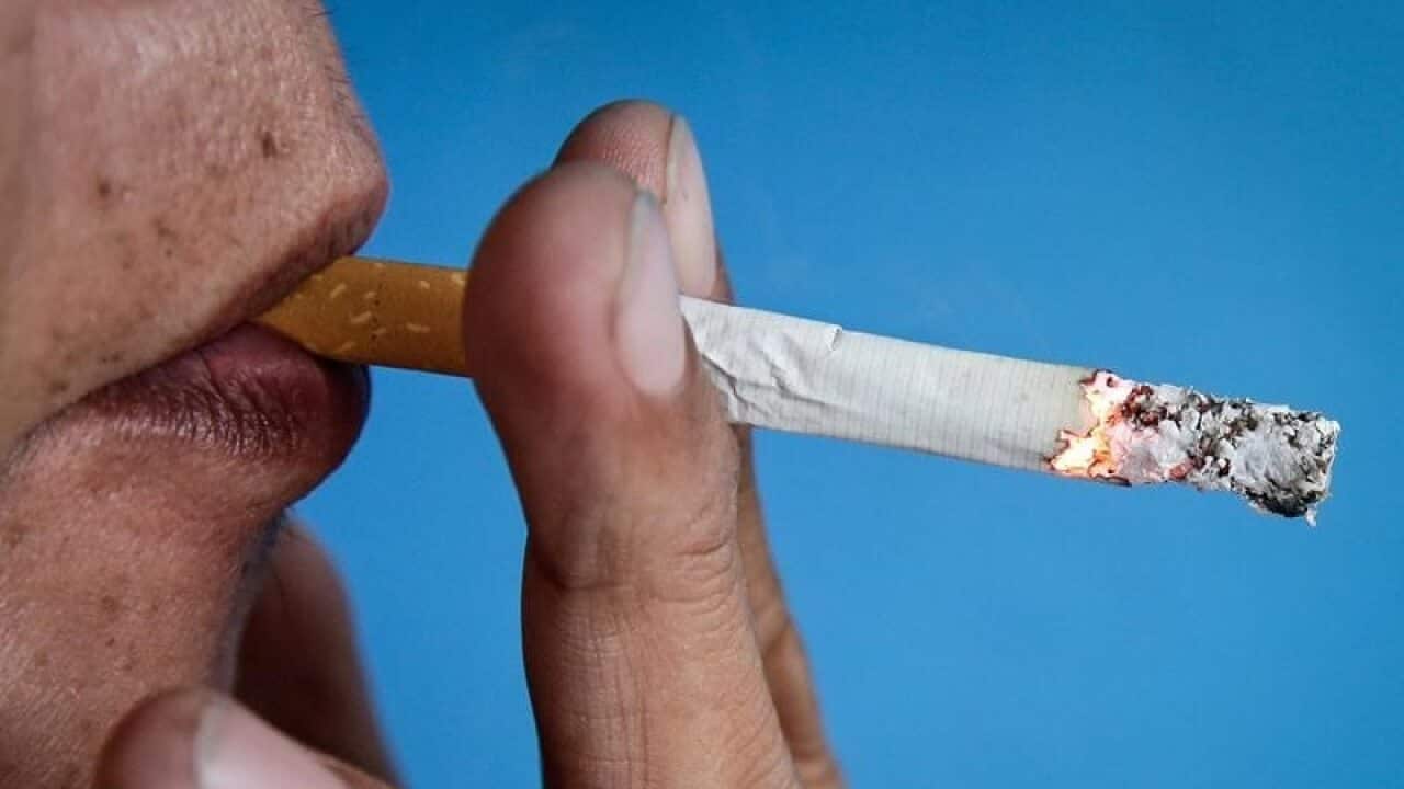 A man smokes a cigarette