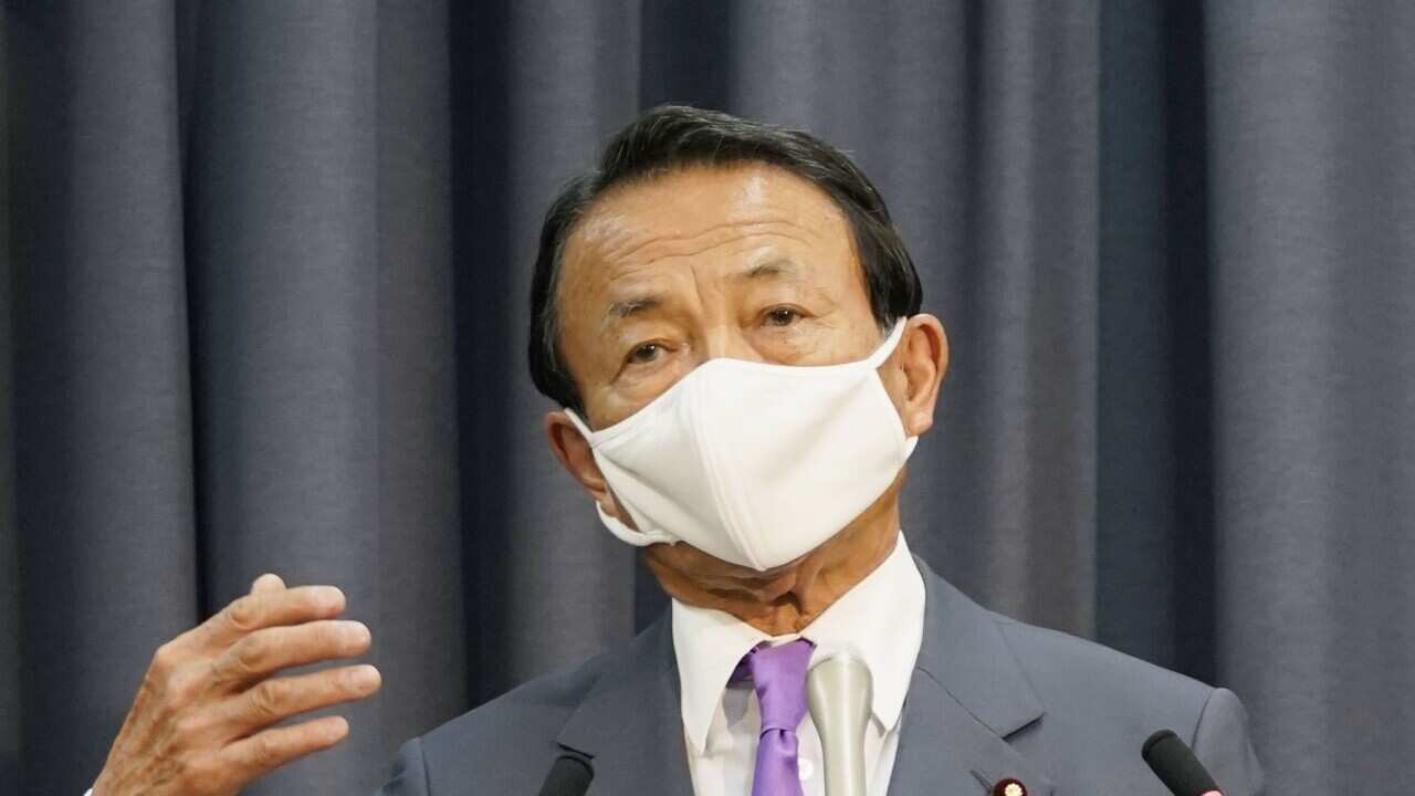 Japanese Finance Minister Taro Aso meets the press in Tokyo on May 27, 2020, after the government approved the second fiscal 2020 supplementary budget plan, focusing on anti-coronavirus measures. (Kyodo via AP Images) ==Kyodo