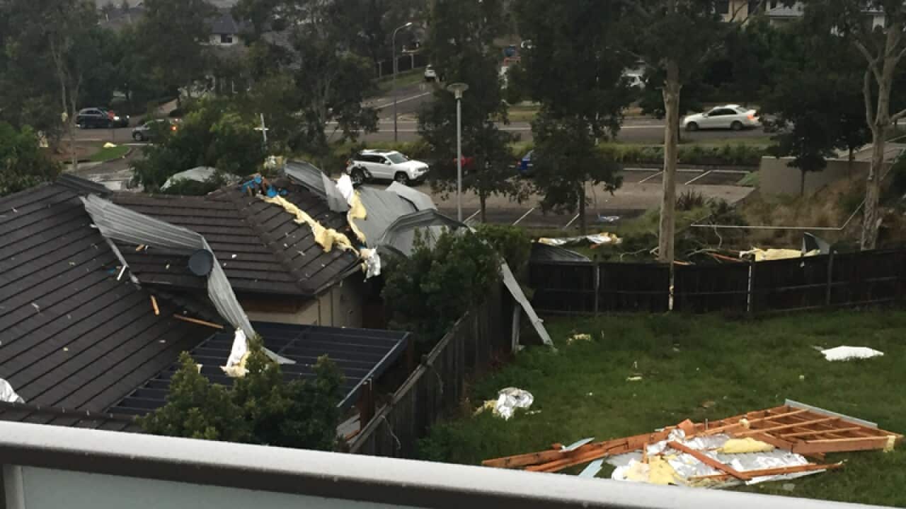 Roof of an apartment building blown off onto neighbouring house
