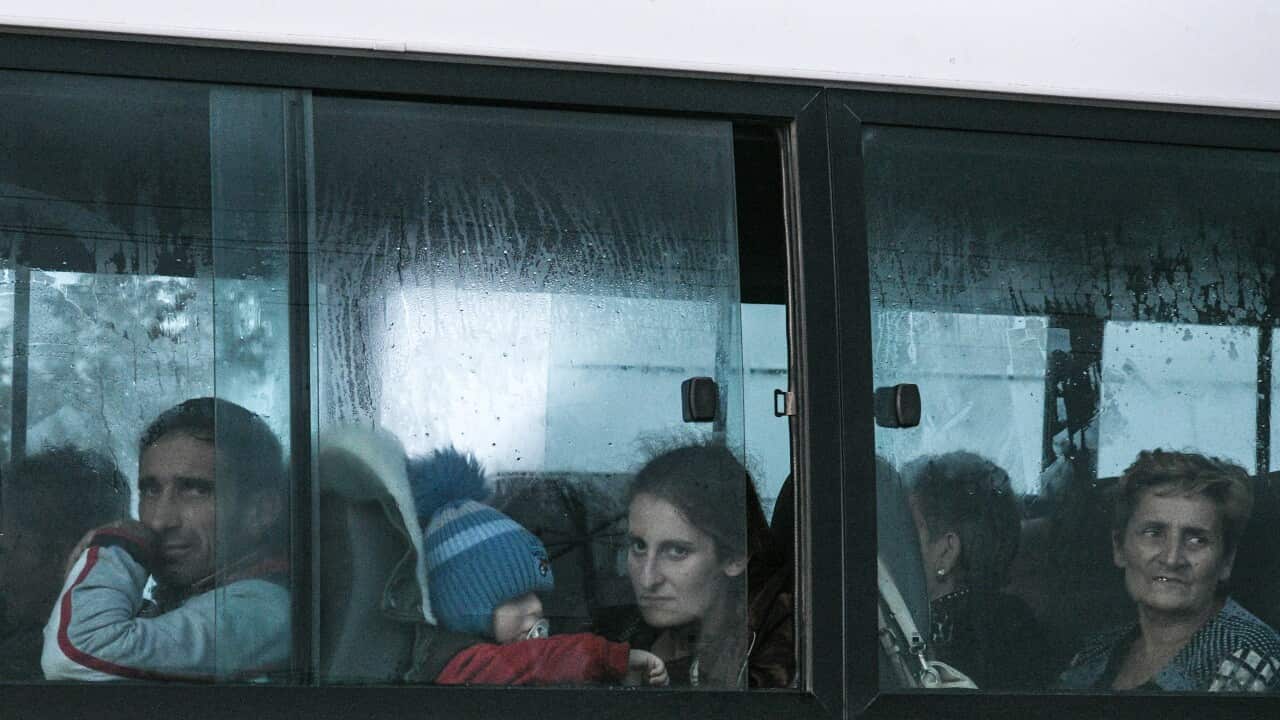Evacuees sitting on a bus from Nagorno-Karabakh