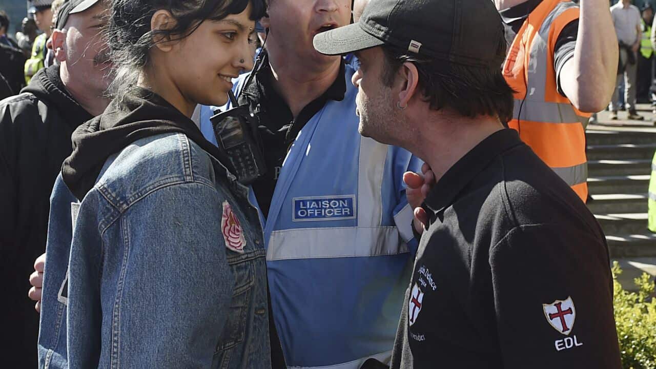 An English Defence League (EDL) protestor, right, clashes with a member of the public during a demonstration in the city of Birmingham, England.