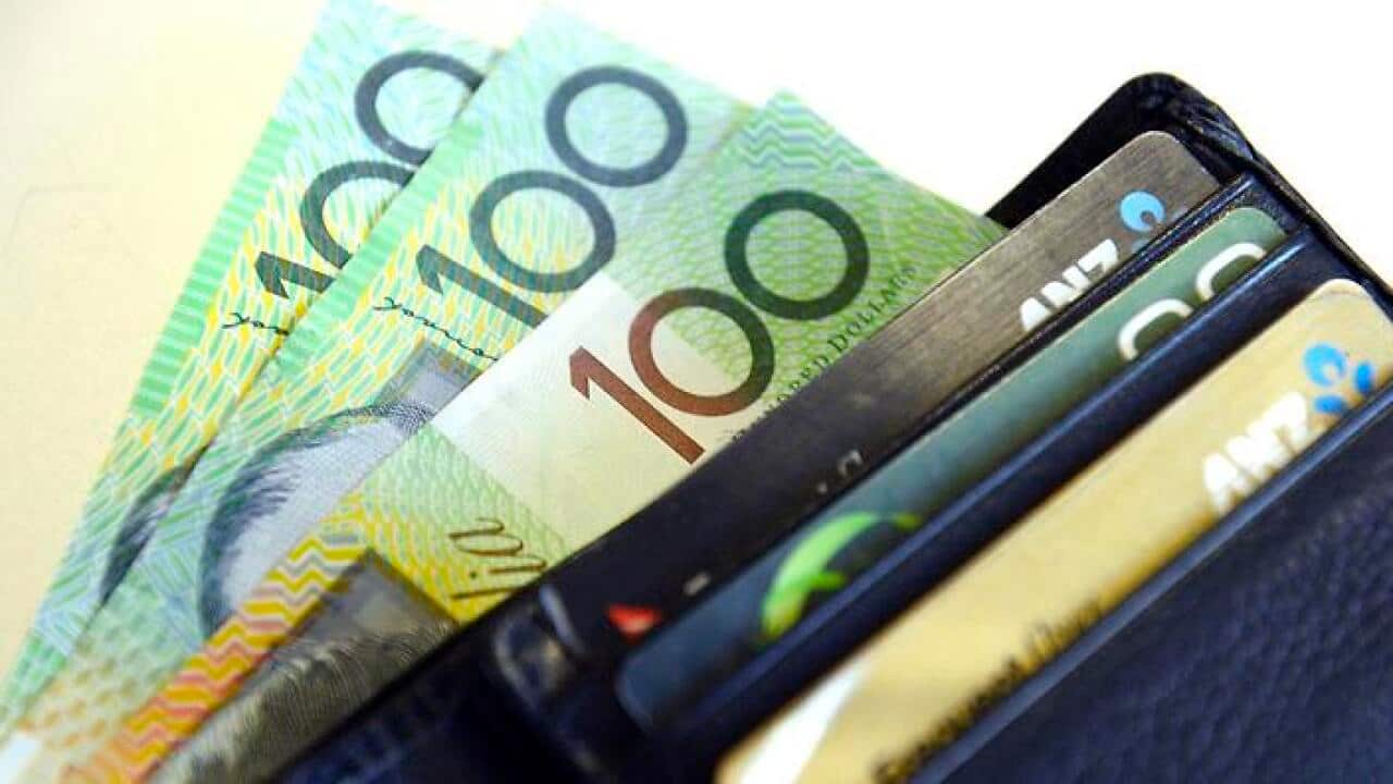 $100 Australian dollar notes pop out of a wallet with credit cards, pictured in Brisbane, Tuesday, Aug. 20, 2013. (AAP Image/Dan Peled) NO ARCHIVING
