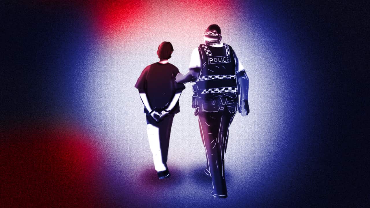 An image showing a police officer leading a young person away in handcuffs.