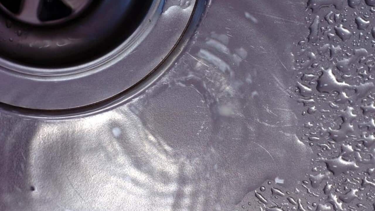 A drain in a kitchen sink