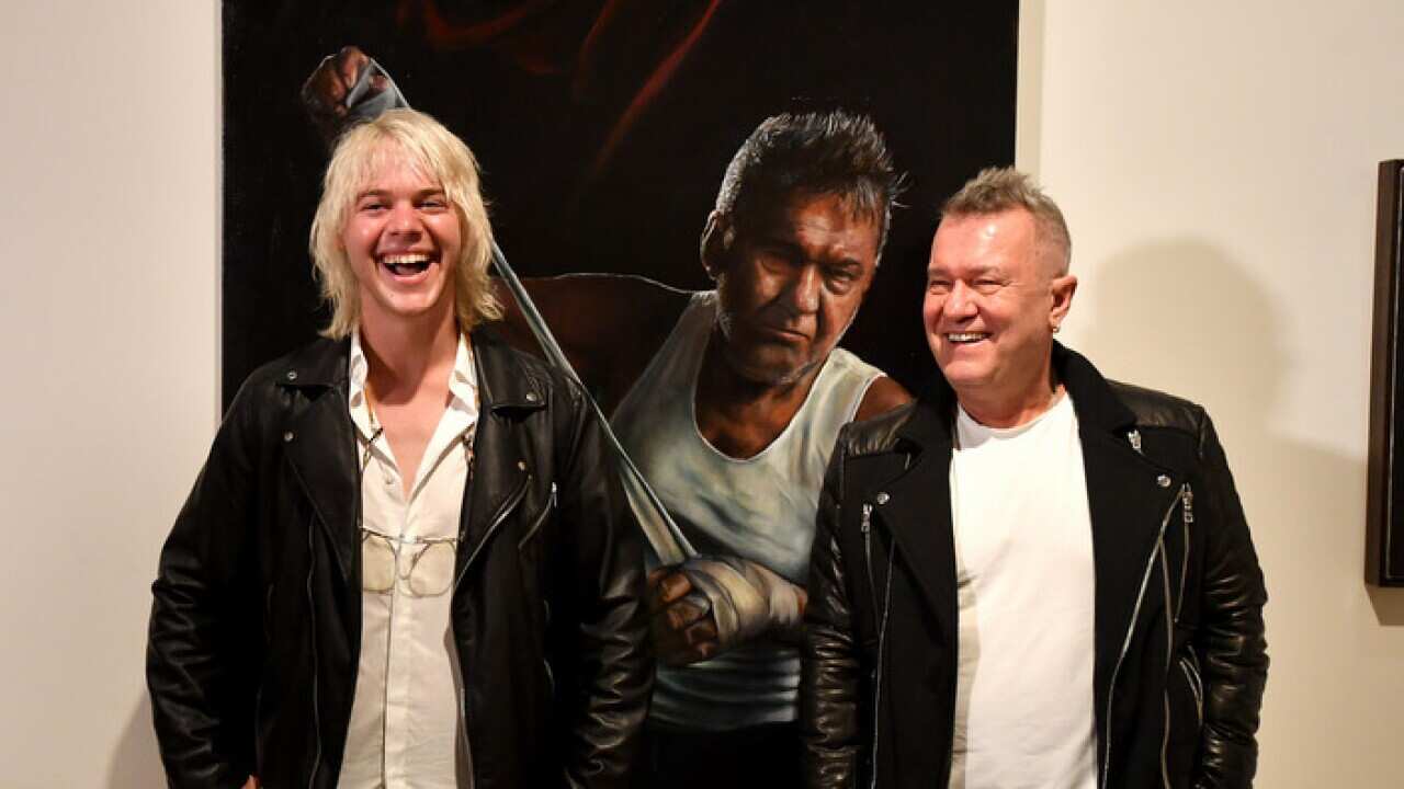 Artist Jamie Preisz and entertainer Jimmy Barnes pose with the Packing Room Prize winning portrait at the Art Gallery of New South Wales in Sydney, Thursday, May 3, 2018. (AAP Image/Mick Tsikas) NO ARCHIVING