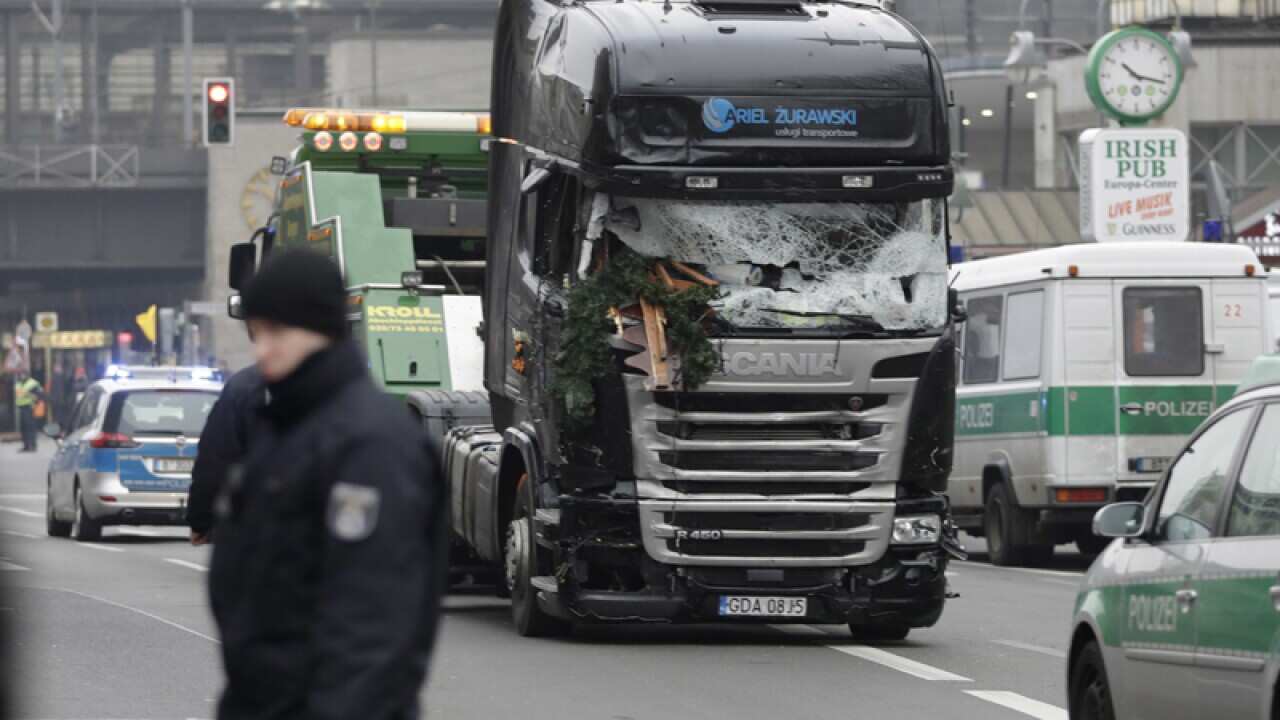 The damaged towing truck is towed away from the crime scene in Berlin