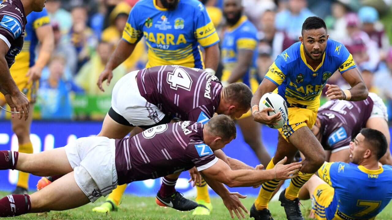 Bevan French of the Eels evades a tackle