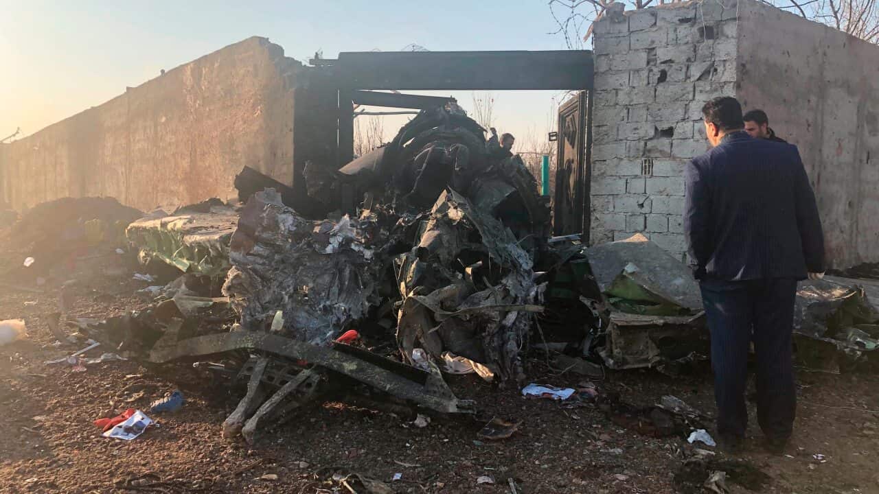Wreckage left by the crashed passenger jet on the outskirts of Tehran, Iran.