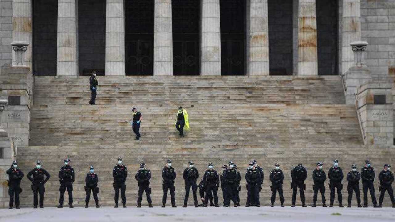 Police are seen at the Shrine of Remembrance before a planned anti-lockdown protest in Melbourne, Saturday 12 September.