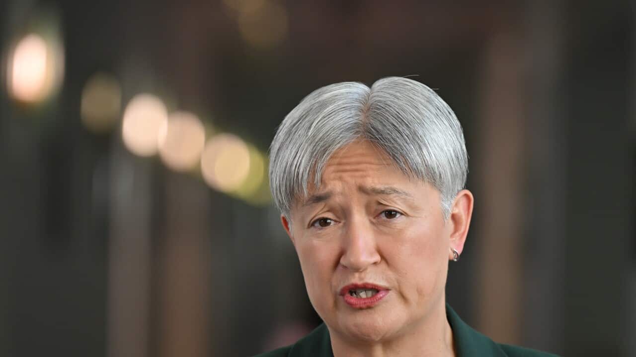 A woman with grey hair speaks