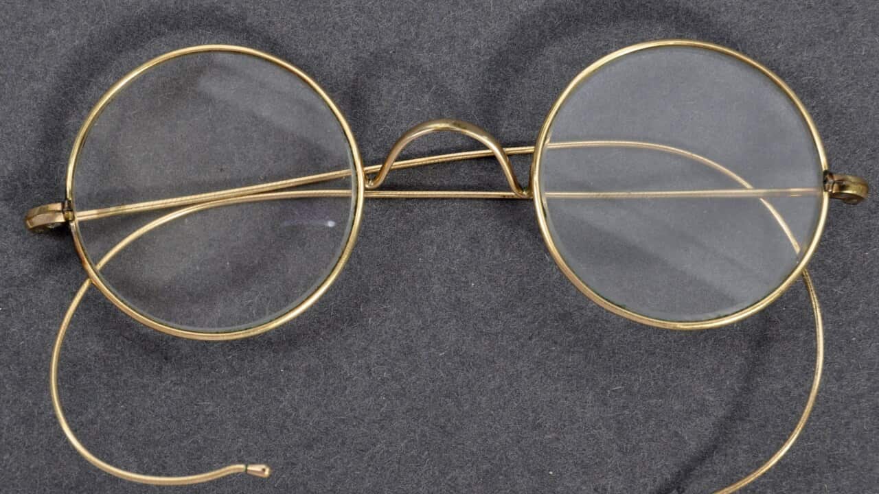 A pair of eyeglasses that are believed to have once belonged to Mohandas Gandhi are laid out on display