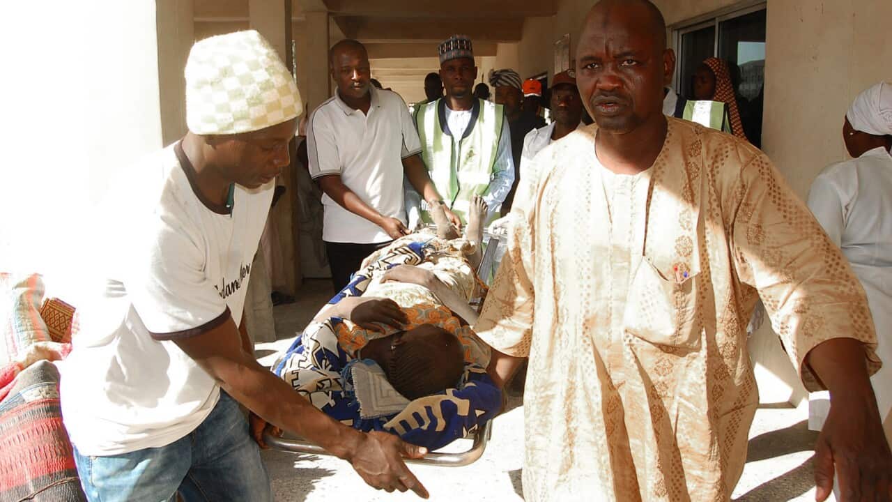 Rescue workers transport a victim of a suicide bomb attack at a refugee for treatment at a hospital, in Maiduguri, Nigeria, Wednesday, Feb. 10, 2016.