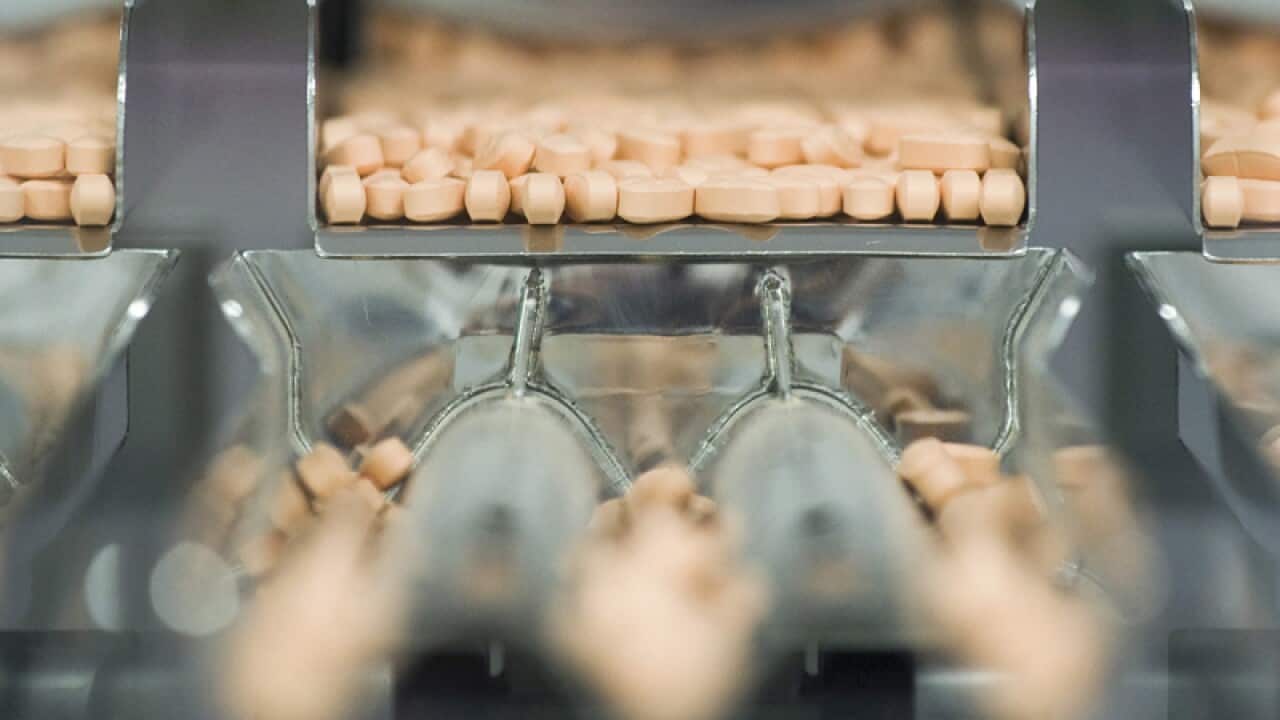 Centrum multivitamins are shown on the packaging line