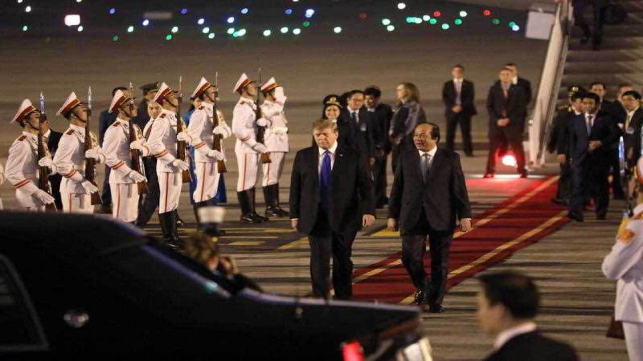 US President Donald J. Trump (C-L) is welcomed upon his arrival at Noi Bai International Airport