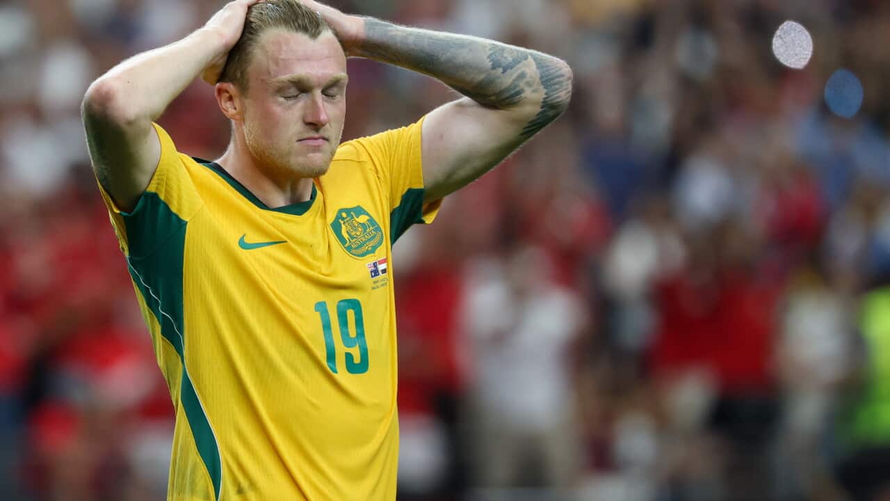 A football player holding his hands on his head