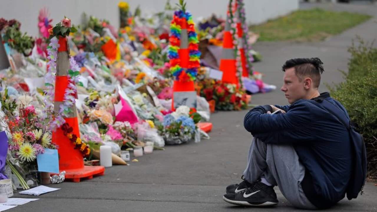 A student paying his respects at a park outside the Masjid Al Noor mosque in Christchurch.