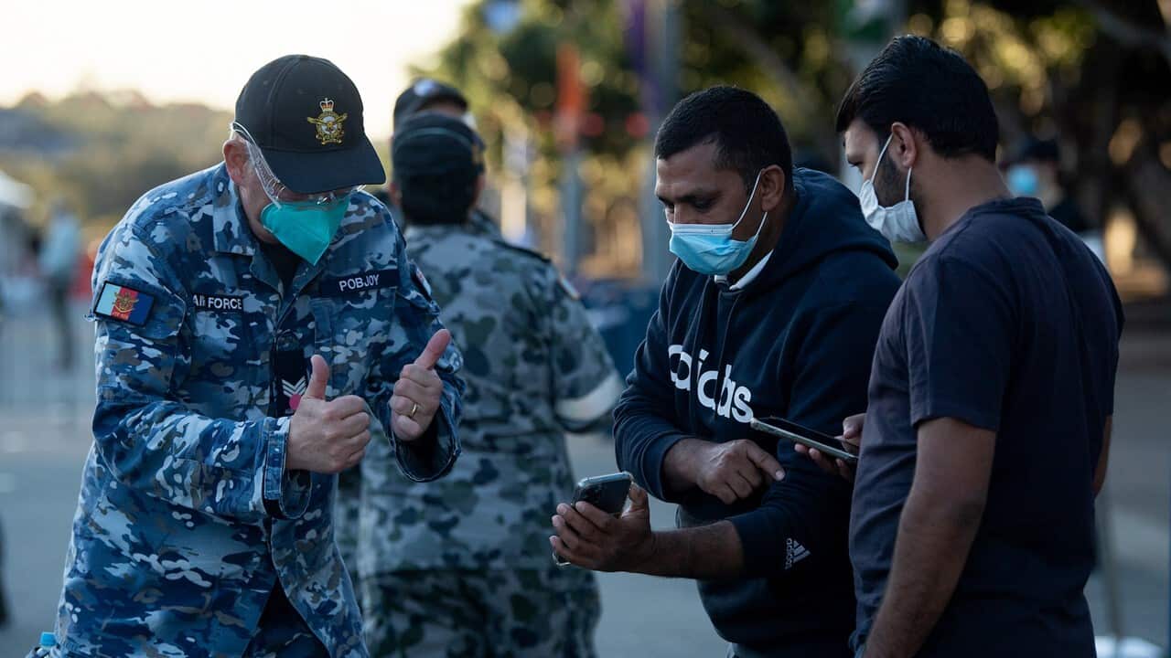 Australian Defence Force personnel assist people as they check into the Qudos Bank Arena NSW Health COVID-19 Vaccination Centre in Sydney, August 16, 2021.